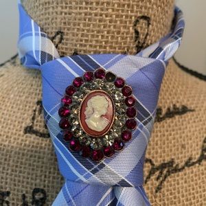 vintage tie with rhinestone brooch.